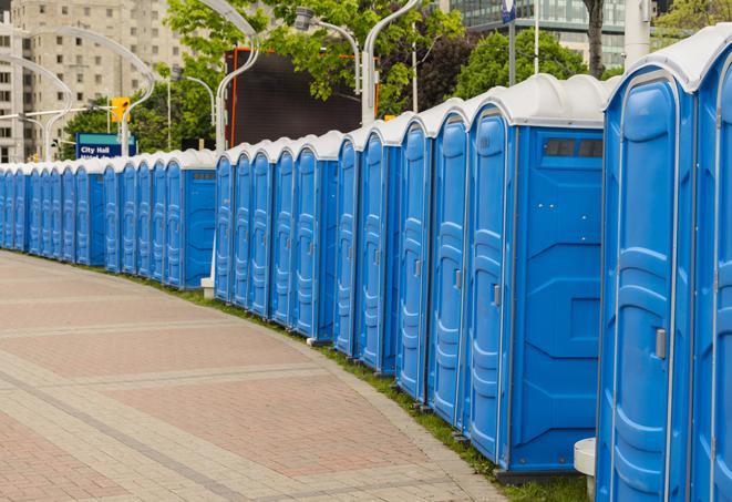 a row of portable restrooms at an outdoor special event, ready for use in Coppell